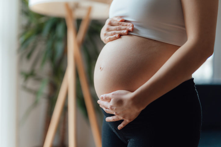 Photo shows pregnant woman holding her belly/Getty Images