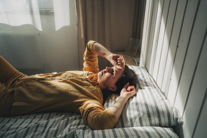 Photo shows a woman lying in bed/Getty Images