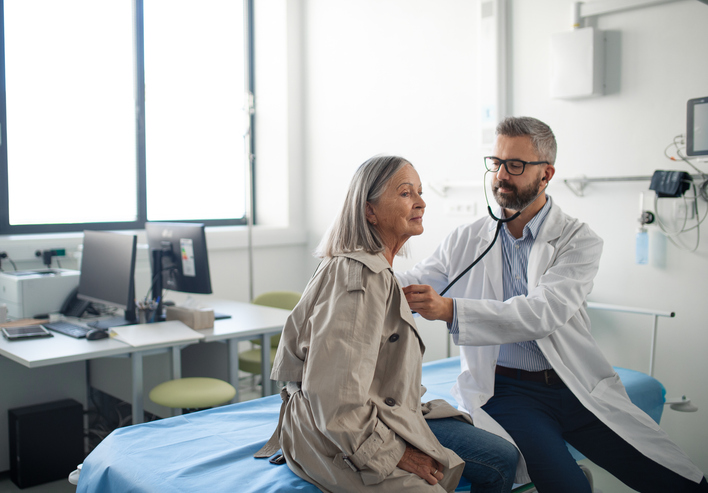 Photo shows a senior woman being examined by her doctor/Getty Images