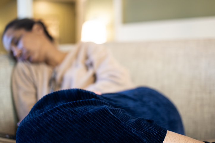 Photo shows a woman taking a nap on her sofa/Getty Images