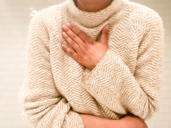 Photo shows a woman experiencing shortness of breath/Getty Images