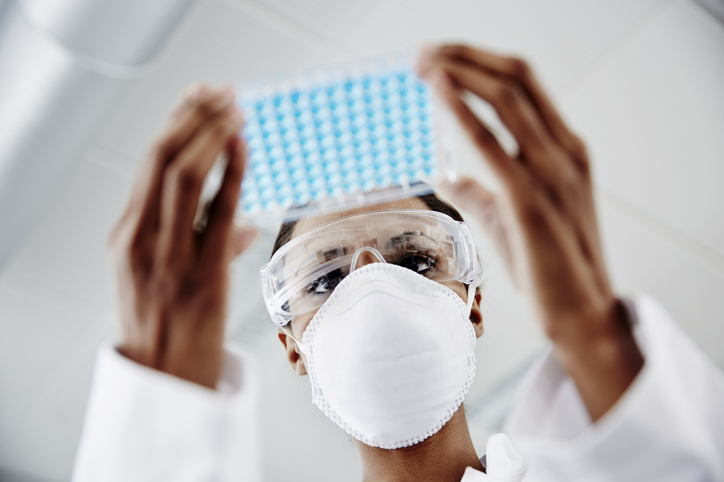 Photo shows a researcher examining laboratory samples/Getty Images