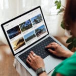 Photo shows woman using laptop